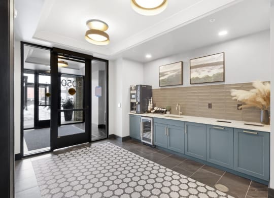 a kitchen with blue cabinets and a black and white rug