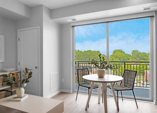 a seating area with a table and chairs in a 555 waverly unit