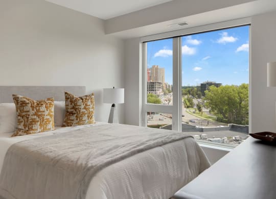 a bedroom with a large bed and a large window