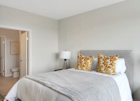 a bedroom with a large bed and a door to a bathroom