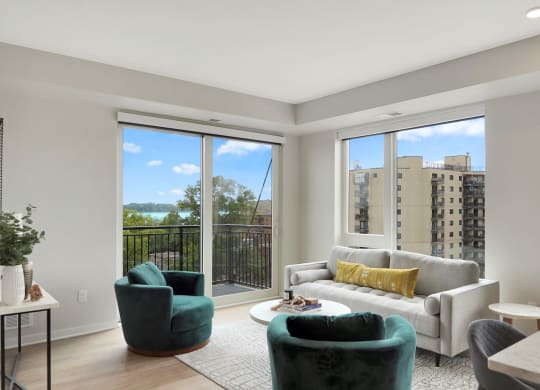a living room with a large window and a balcony