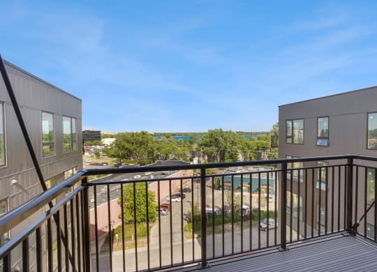 a balcony with a view of a parking lot
