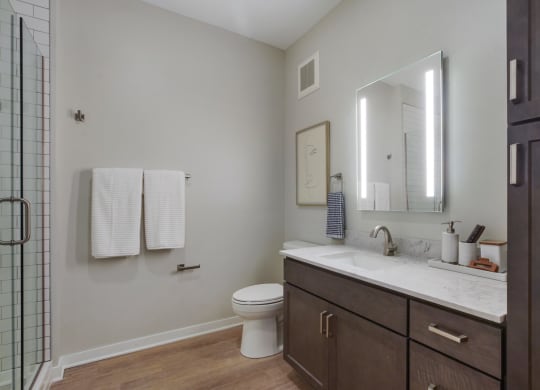 a bathroom with gray walls and a wooden floor