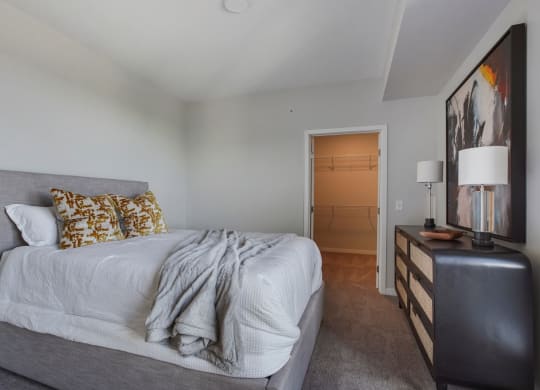 a bedroom with a bed and a dresser