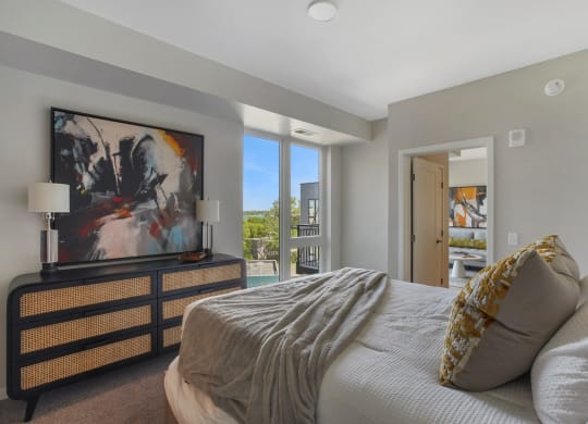 a bedroom with a large bed and a large window