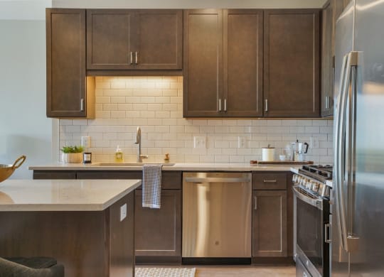a kitchen with wood cabinets and stainless steel appliances