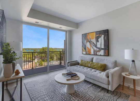 a living room with a couch coffee table and a large window