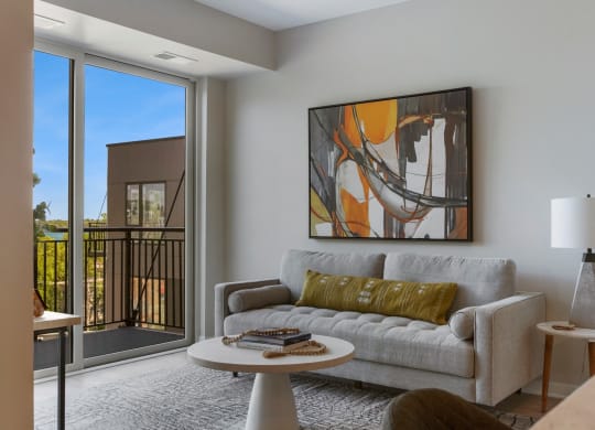 a living room with a couch a table and a window