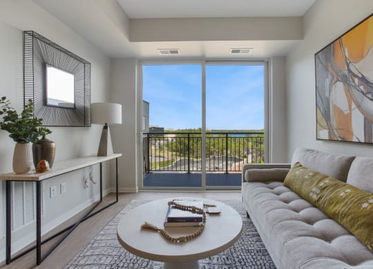 a living room with a couch coffee table and a large window