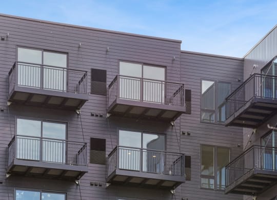 a view of the exterior of a building with multiple balconies