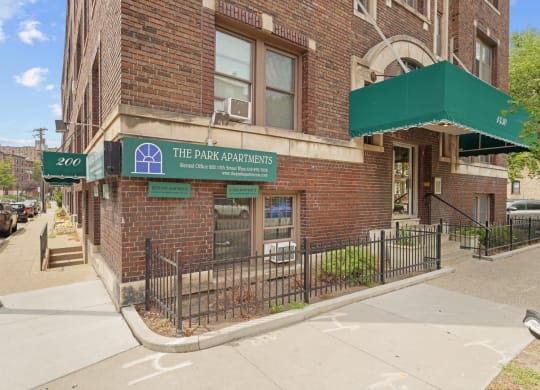 a building with a green awning and a sign that reads the park condominiums