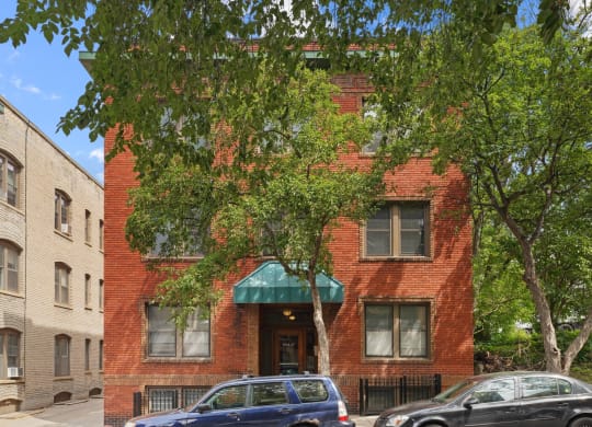a red brick building with a green awning