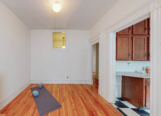 A room with a yoga mat on the floor.