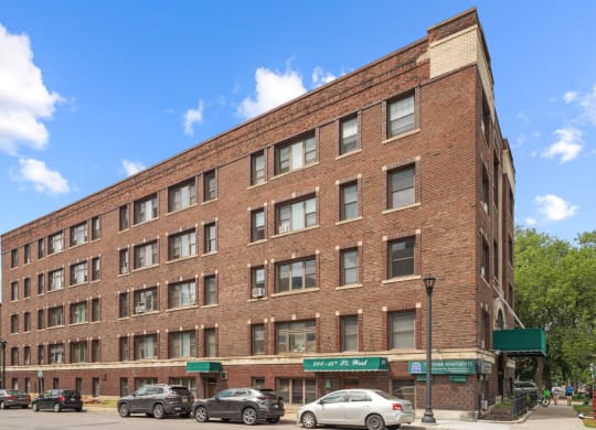 a large brick building with cars parked in front of it