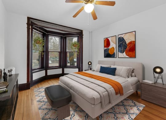a bedroom with a bed and a large window