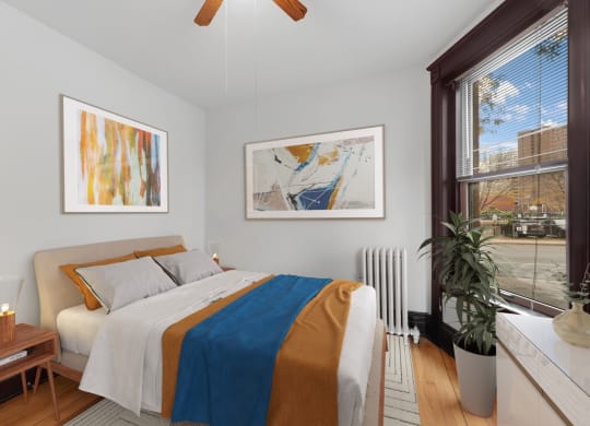 a bedroom with a bed and a large window