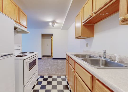 a kitchen with white appliances and wooden cabinets
