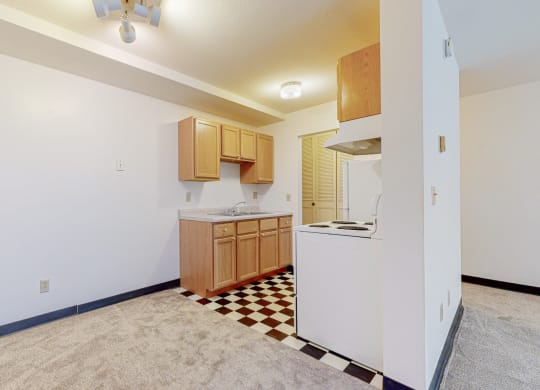 a kitchen with a white refrigerator freezer next to a stove top oven