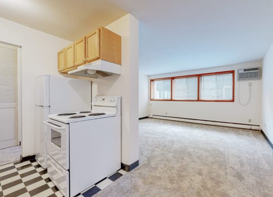a kitchen with white appliances and a black and white checkered floor