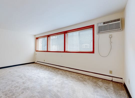 a bedroom with white walls and carpet