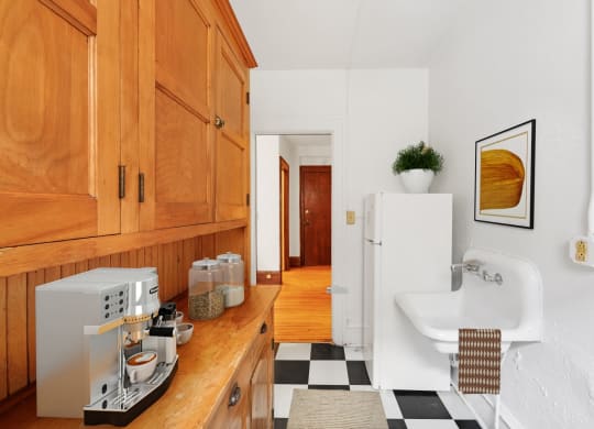a kitchen with wooden cabinets and a black and white checkered floor