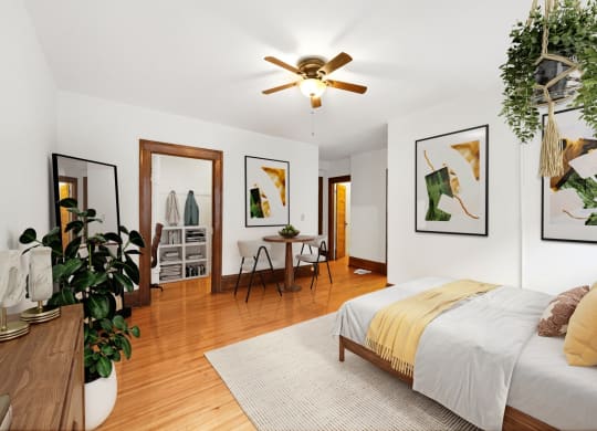 a bedroom with a bed and a ceiling fan