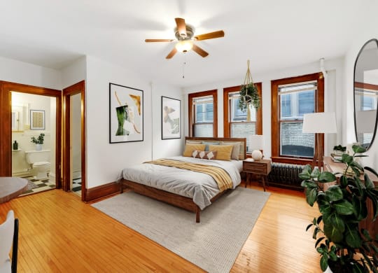 a bedroom with a bed and a ceiling fan