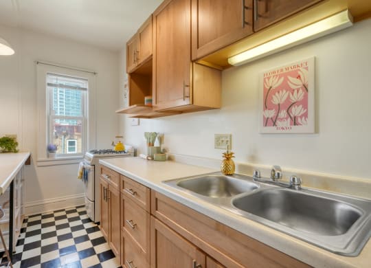 a kitchen with wooden cabinets and a checkered floor