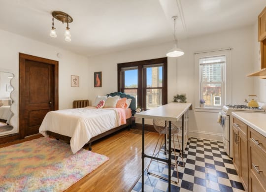 a bedroom with a bed and a desk with a chair