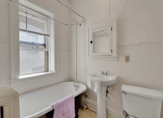 a small bathroom with a tub and sink