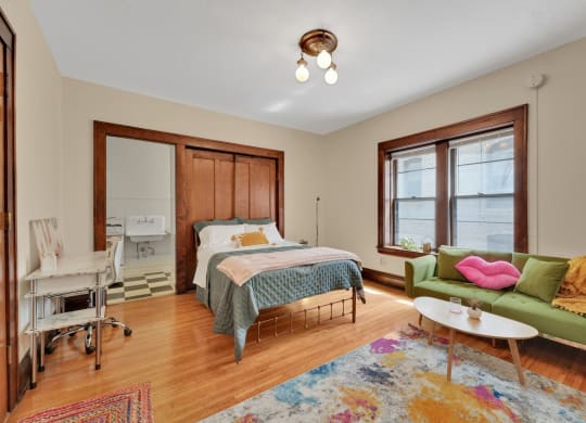 a bedroom with a bed and a couch