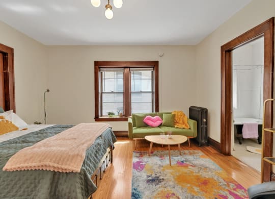 a bedroom with a bed and a couch