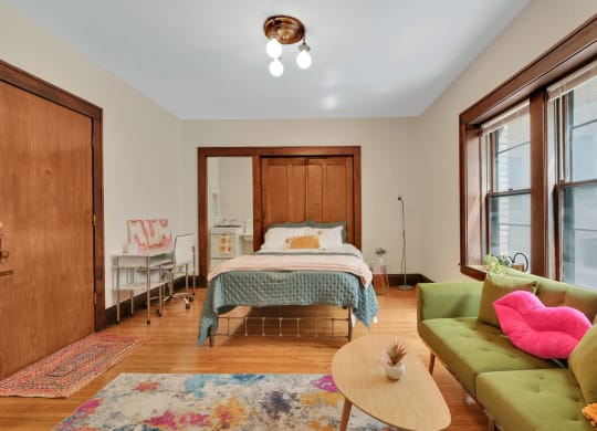 a bedroom with a bed and a couch
