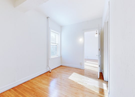 Spacious, Open Concept Bedroom with Restored Hardwood Flooring at The Park Apartments in Minneapolis, MN