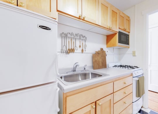 Cozy Kitchen With Natural Wood Cabinetry at The Park Apartments in Minneapolis, 55403