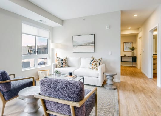 a living room with a couch and chairs and a table