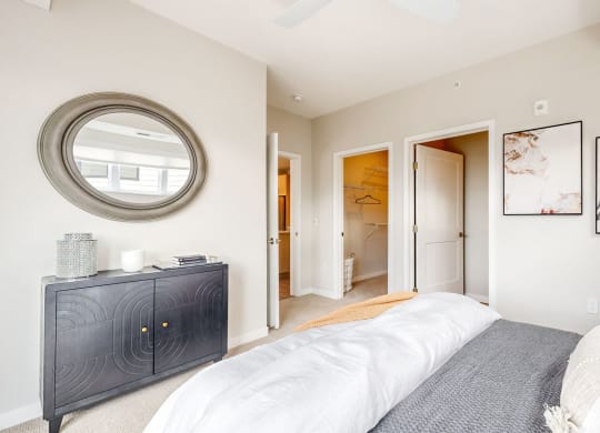 a bedroom with a large bed and a mirror