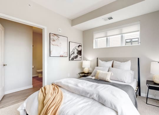 a bedroom with a large bed and a window