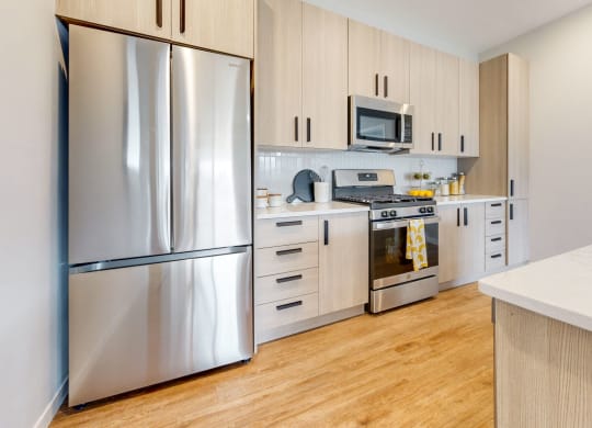 a kitchen with stainless steel appliances and white cabinets