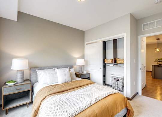 A bedroom with a large bed and a window.