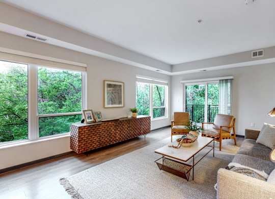 A living room with a couch, chair, and a table.