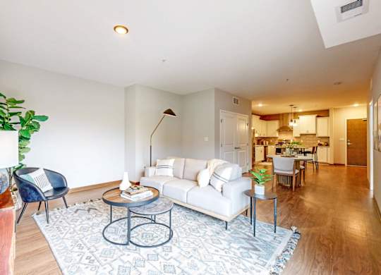 A living room with a white couch and a coffee table.