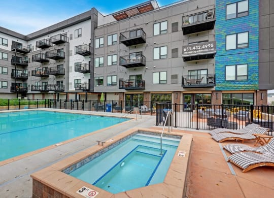 a swimming pool in front of an apartment building