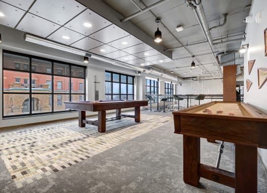a games room with shuffleboard tables and ping pong tables at The Yards and Backyards, Saint Paul, MN