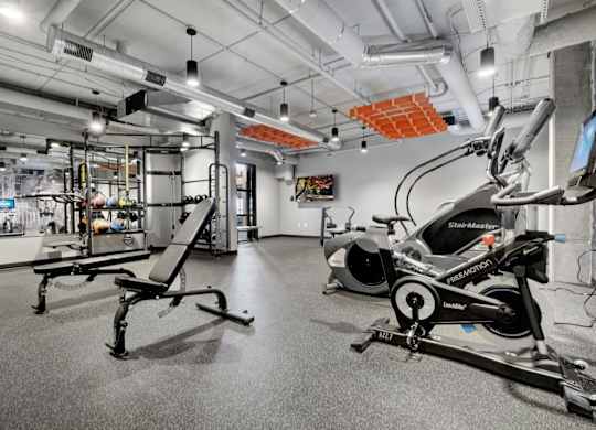 fitness center with black rubber floors, strentgth and cardio equipment