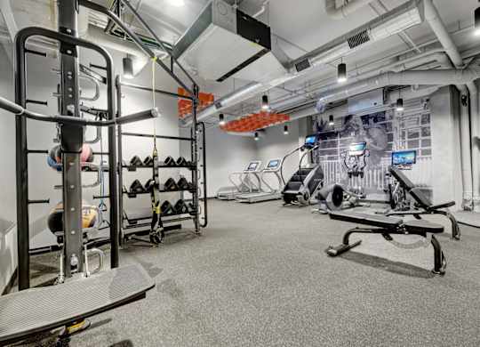 fitness center with black rubber floors, strentgth and cardio equipment