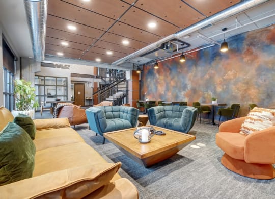 a large room with couches chairs and a coffee table at The Yards and Backyards, Saint Paul