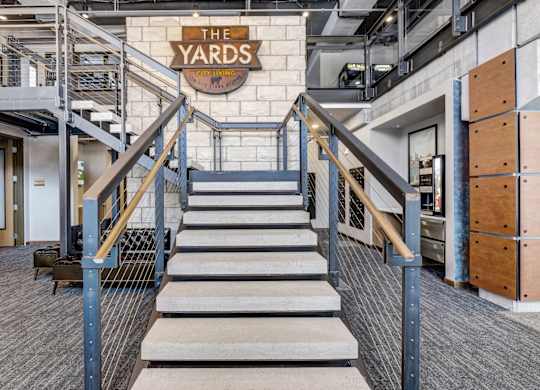 a staircase with a large sign that says the yards on the top of it