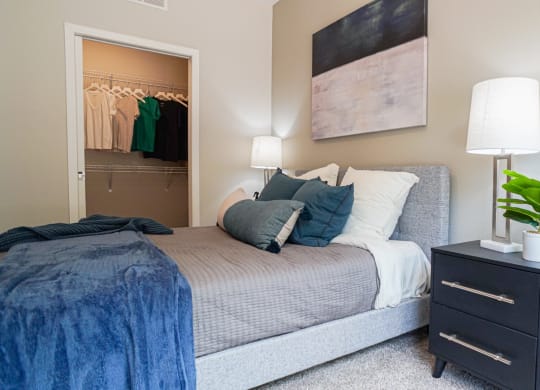 a bedroom with a bed and a dresser with a plant at The Yards and Backyards, Minnesota