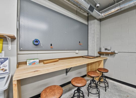 a long wooden table with stools in front of it
